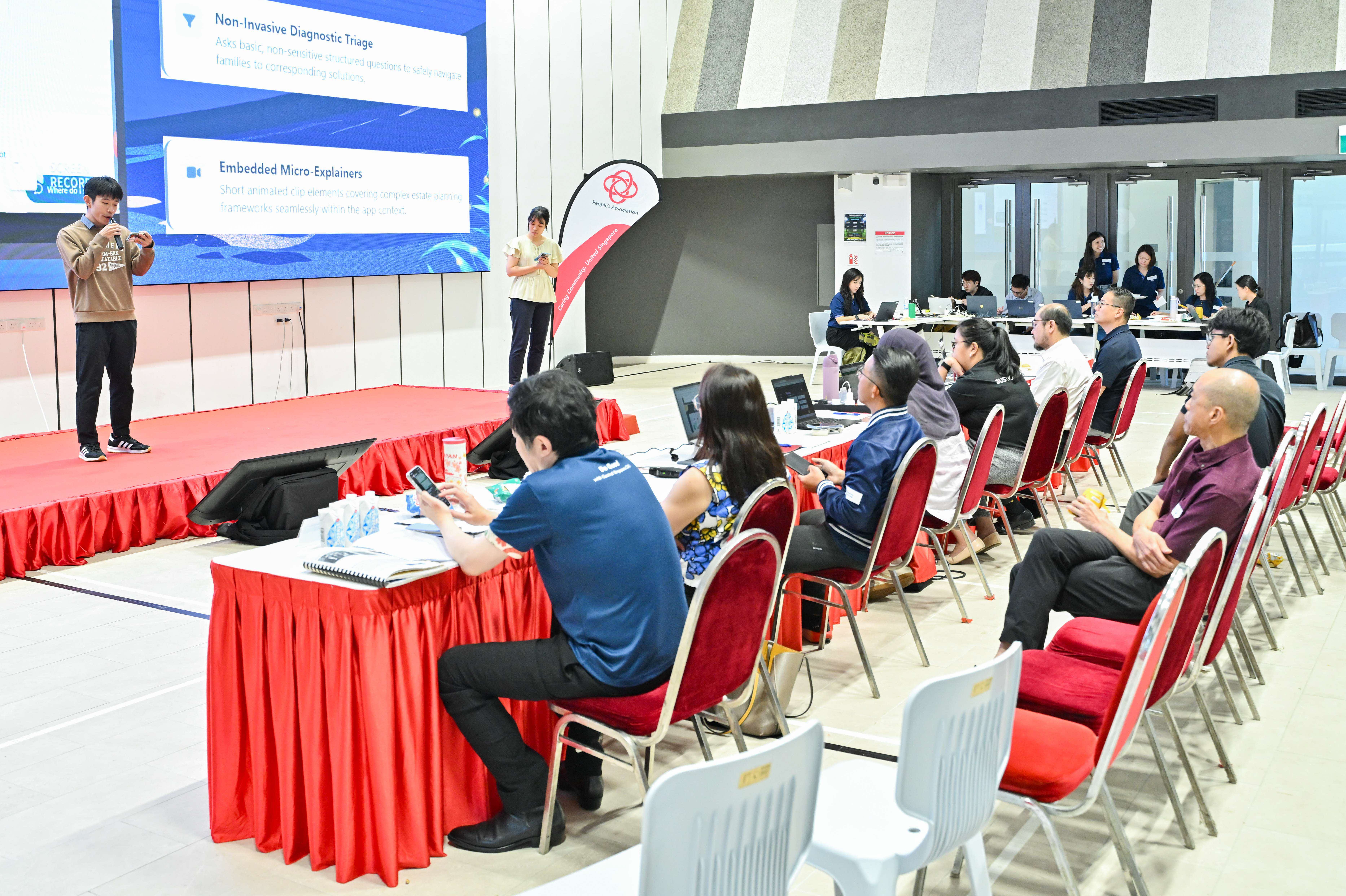 Two students explaining to the audience and panel